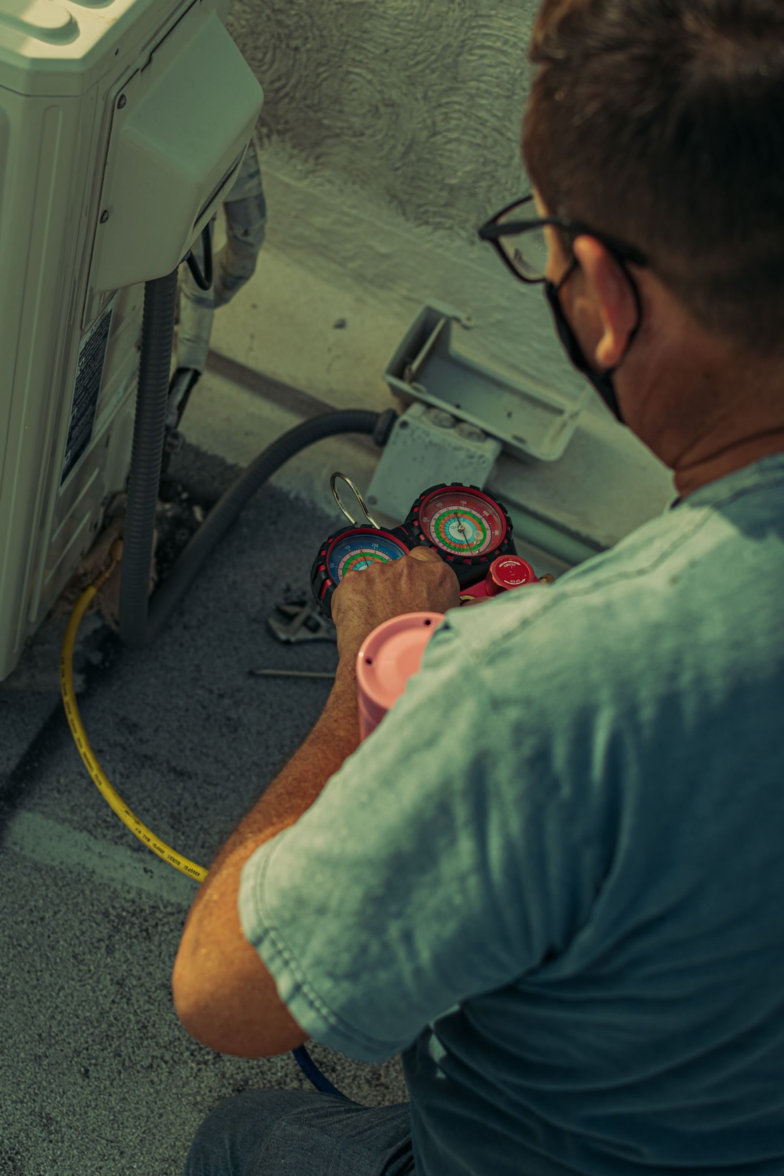 Above Air technician servicing an air conditioning system