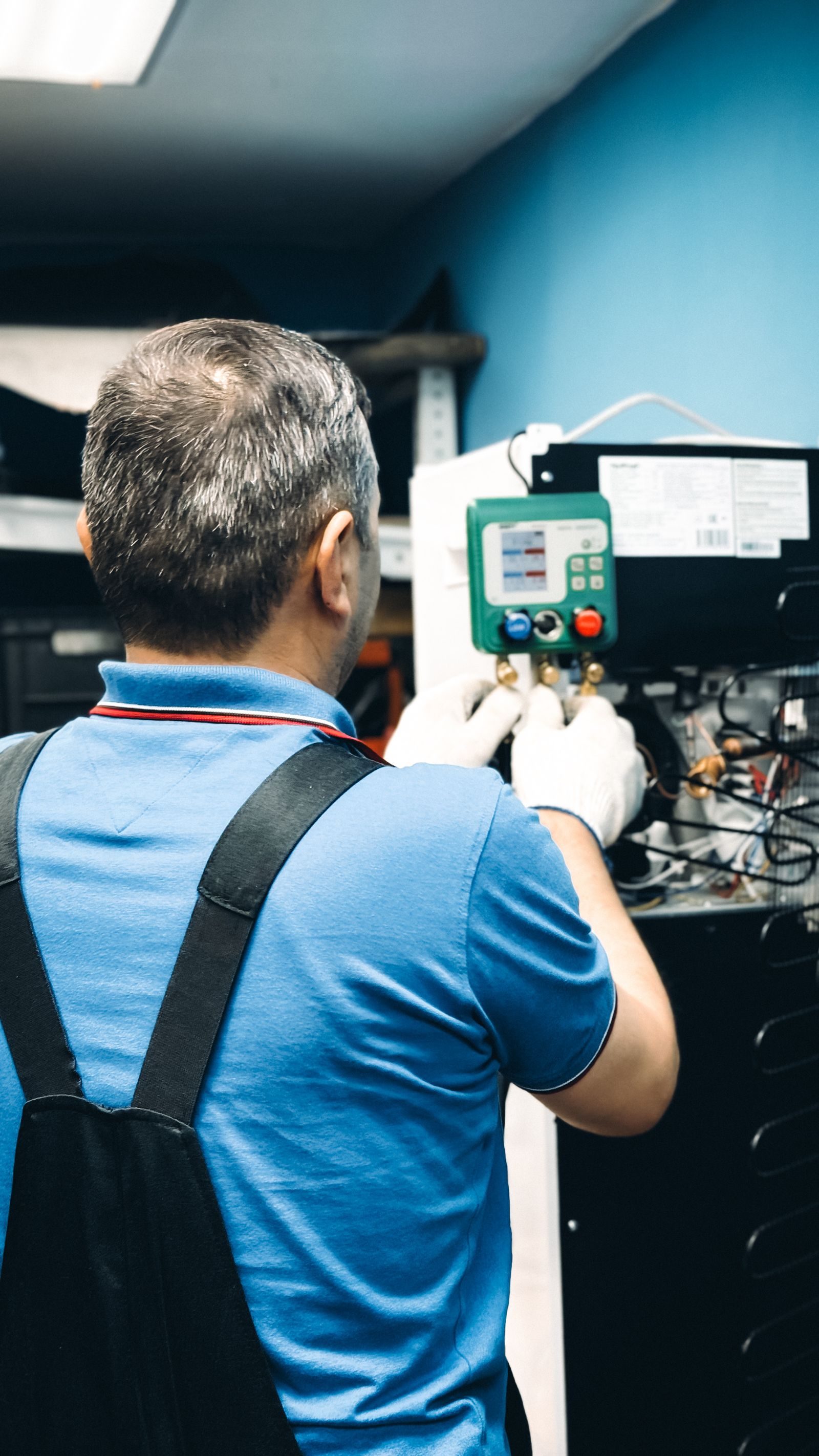 Technician working inside an air handler cabinet